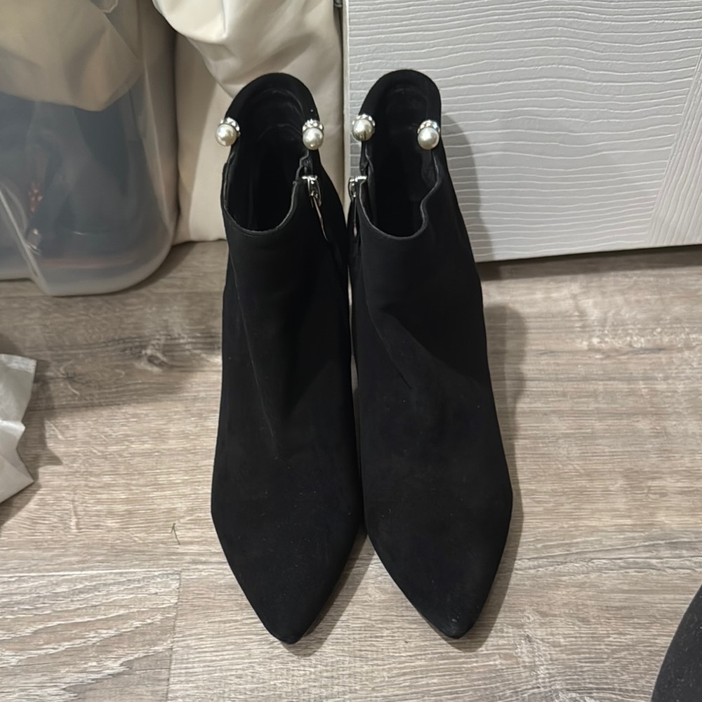 Black booties with pearls at the ankles.